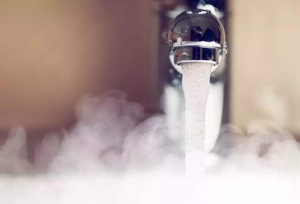 Domestic hot water temperature UK – a picture showing hot water flowing out of a tap